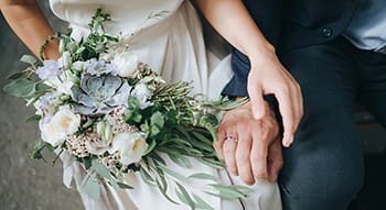 a wedding couple hold hands